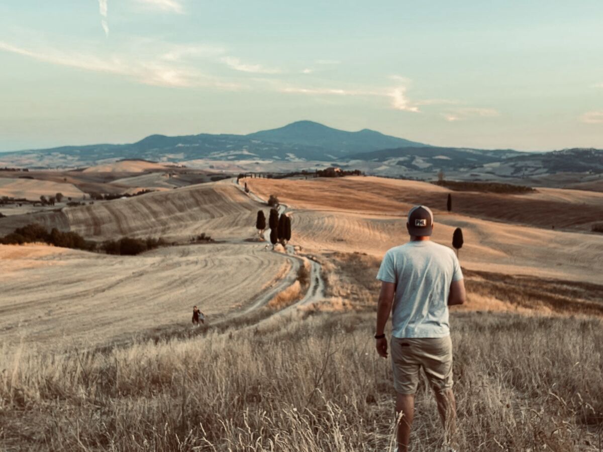 Person overlooking rolling hills representing the journey of AI implementation