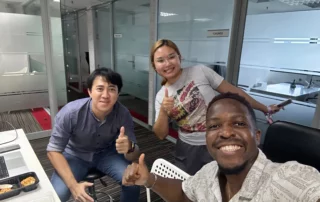 Chris takes a selfie with Gam and James whilst having lunch in the Bangkok office. Thumbs up all round