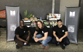 Gomez, Tom and Dylan pose for a photo in front of the MOHARA stall at the Stellenbosch Career Fair in Cape Town, ready to talk to young, eager and curious students